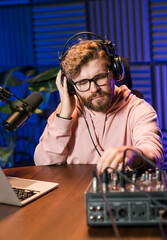 Handsome man radio DJ hosting a radio show, entertainment and communication concept