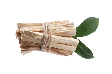 Palo santo sticks and green leaves on white background