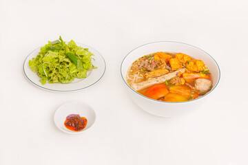 Bun Rieu Cua, Crab paste vermicelli soup with minced shrimp, tofu, tomato, shrimp paste, Vietnamese food isolated on white background, close up