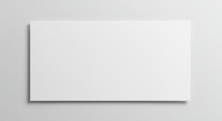 Fototapeta premium A plain rectangular piece of white paper set against a white background