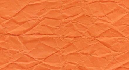 Fototapeta premium A texture of vibrant orange tissue paper crumpled and wrinkled to create random patterns