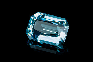 faceted aquamarine stone on a black background