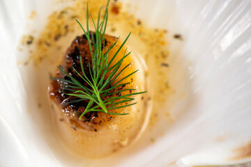 Grilled scallops with butter, quinoa pop, garlic, lime