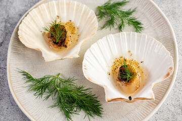 Grilled scallops with butter, quinoa pop, garlic, lime