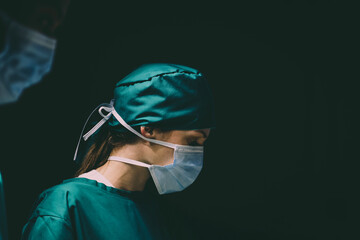 female caucasian doctor operating emergency room. specialist surgical woman determined doing...