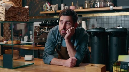 Disappointed Caucasian waiter man barista boredom in cafeteria exhausted employer problem bartender male entrepreneur leaning counter waitstaff overworking cafe guy contemplate small business stress