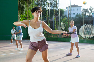 Latin woman playing frontenis on outdoor pelota court during training. Woman playing Basque pelota speciality.
