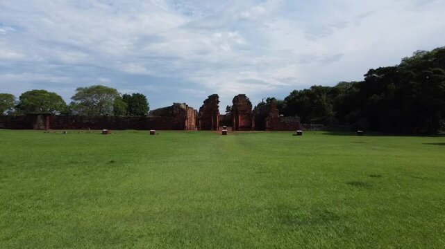 skimming flight that rises towards the Ruins of San Ignacio, Misiones. Captures the architectural evolution and mystery of the place.