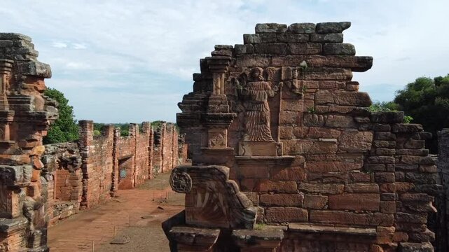 Detailed close-up of the angel carved on the portal of San Ignacio, Misiones. Captures the artistic precision and unique texture of the stone.