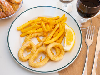 Appetizing andalusian fried squid rings served on plate in restaurant
