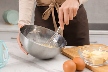 Woman making dough at white marble table indoors, closeup