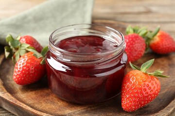 Delicious strawberry sauce and fresh berries on wooden table, closeup