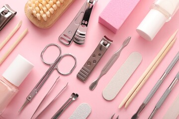 Set of different manicure tools on pink background, flat lay