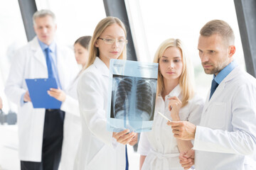 a group of doctors are meeting in a hospital