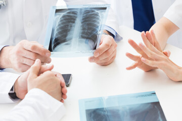 a group of doctors are meeting in a hospital