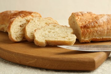 Slices of fresh bread on light textured table, closeup