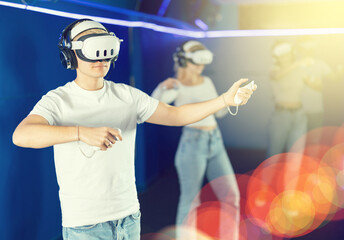 Guy in a VR helmet is learning to dance and new moves. European learns to dance with virtual...
