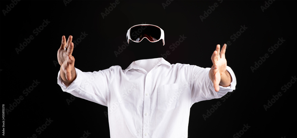 Leinwandbilder A user in a white shirt is immersed in virtual reality, wearing goggles while gesturing with hands. The background is completely dark, emphasizing the technology and user involvement.