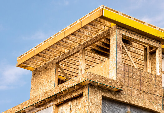 Roof construction detail showing engineered wood joists and Laminated Veneer Lumber (LVL) headers  with oriented strand board, Chip board wall sheathing