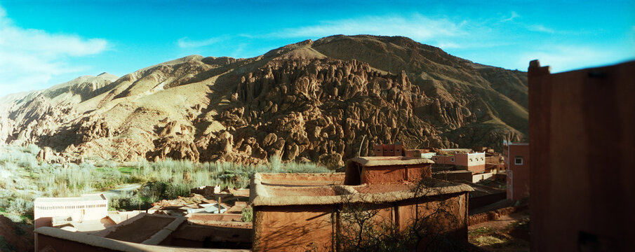 Panoramic view of houses with mountain range in the background, Draa Valley, Morocco.