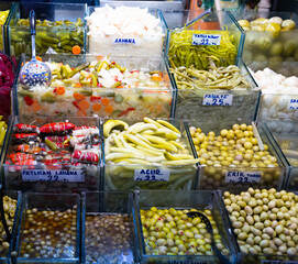 Assortment of marinated pickled vegetables in plastic boxes at the market