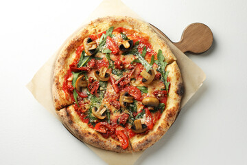 Tasty pizza with mushrooms, tomatoes and arugula on white table, top view