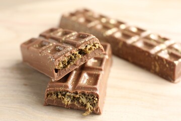 Delicious Dubai chocolate bars on wooden table, closeup