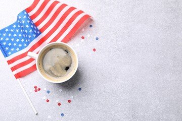 Cup of coffee, confetti and American flag on light table, flat lay. Space for text