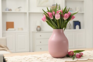 Bouquet of beautiful tulips in vase on table indoors, space for text