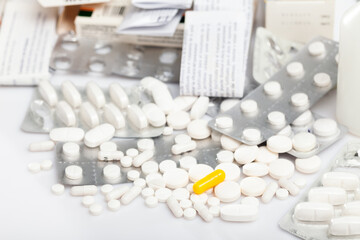 Different pills spilled on white background, pharmaceutical medicaments