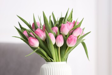 Bouquet of beautiful tulips in vase indoors, closeup