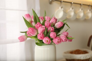Bouquet of beautiful tulips in vase indoors, closeup