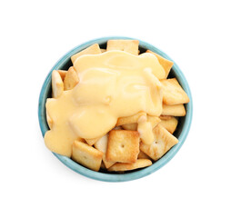 Crackers with tasty cheese sauce in bowl isolated on white, top view