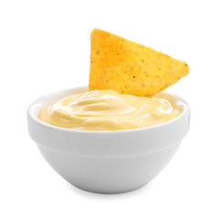 Tasty cheese dipping sauce in bowl and nacho chip isolated on white