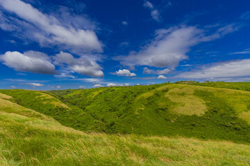 Obraz premium Beautiful landscape of green hills with clouds and blue sky. Panoramic viewpoint EL CRUCERO overlooking the green hills