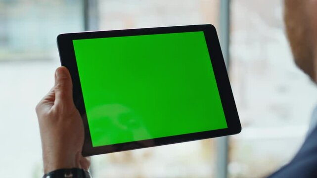 Businessman tapping chromakey tablet at corporate office closeup. Unknown man