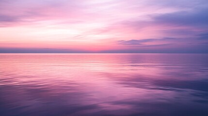 Obraz premium Soft Pastel Sky Glows in Peaceful Reflection Over Ocean’s Calm Surface