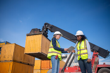 Engineer or dockworker working in the construction container dock yard checking and inspection...