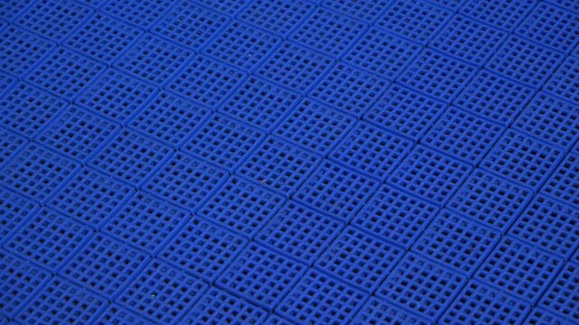 Close up panning shot of outdoor dek hockey rink during the spring summer time
