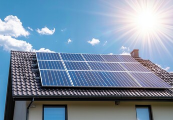 Fototapeta premium Solar panels on the roof of a house with the sun shining, an energy and green concept.
