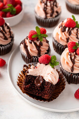 Raspberry chocolate cupcakes with raspberry buttercream frosting and chocolate filling