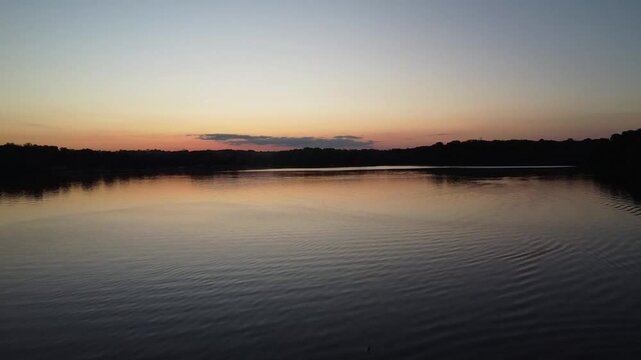Ascending drone footage of the Acton Lake in Hueston Woods State Park, at sunset in Ohio, USA