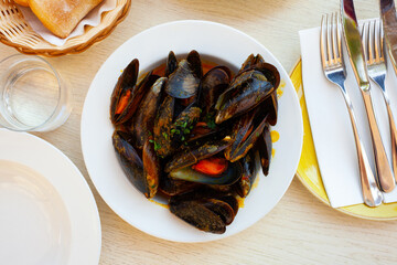 Traditional dish of Spanish cuisine is mussels a la Marinera, cooked with tomato sauce