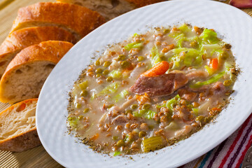 Traditional Scotch broth with barley, stewing shank of lamb, vegetables and peas..