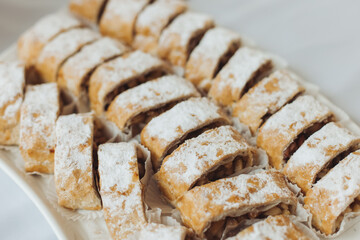 Set of coffee break in the hotel during conference meeting, with tea and coffee catering, decorated catering banquet table with variety of different pastry and bakery, with croissants, pie and cookies