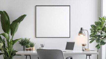 Obraz premium Clean office setup with a framed blank poster hanging on the wall above a desk ideal for branding or creative work