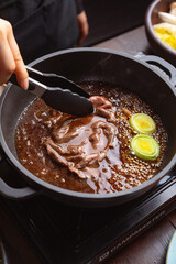 woman in a japanese hotpot restaurant