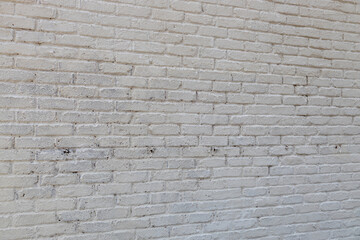 Fototapeta premium Full frame abstract texture background of a grungy white painted antique brick wall that shows some weathering and peeling paint