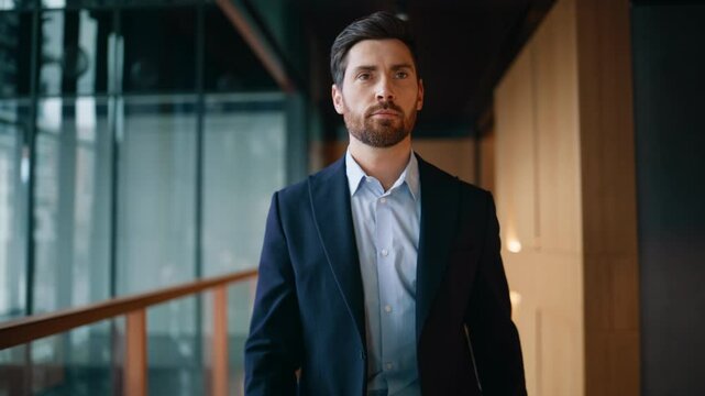 Successful businessman walking corridor pointing finger to camera happy closeup.