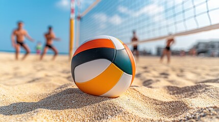 A vibrant beach volleyball rests on the sandy shore, with players engaged in a lively game in the background under a clear blue sky.